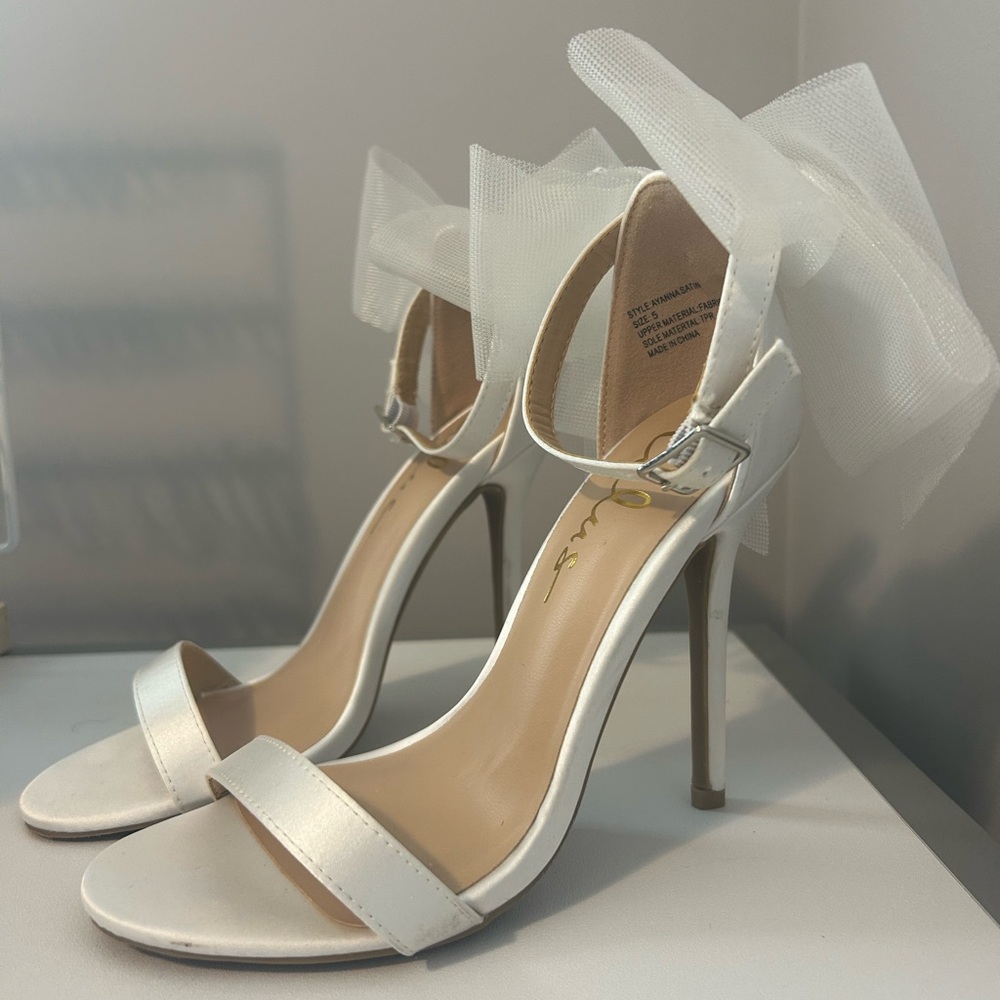 White high heels with bows on back